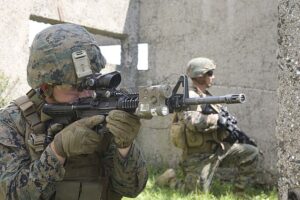 U.S. Marines with Bravo Company, Special Purpose Marine Air-Ground Task Force Crisis Response-Africa, provide security and look for potential enemy sightings before receiving cover from a Bulgarian T-72 tank for the assault on Military Operations on Urban Terrain (MOUT) Town during Platinum Lion 16-3 aboard Novo Selo Training Area, Bulgaria, May 10, 2016. During the exercise, Allies from the United States and four partner nations conducted platoon-level mechanized tactics in order to develop proficiency in fire and maneuver. (U.S. Marine Corps photo by Cpl. Immanuel M. Johnson/Released)