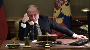 PutinatDesk_on_phone